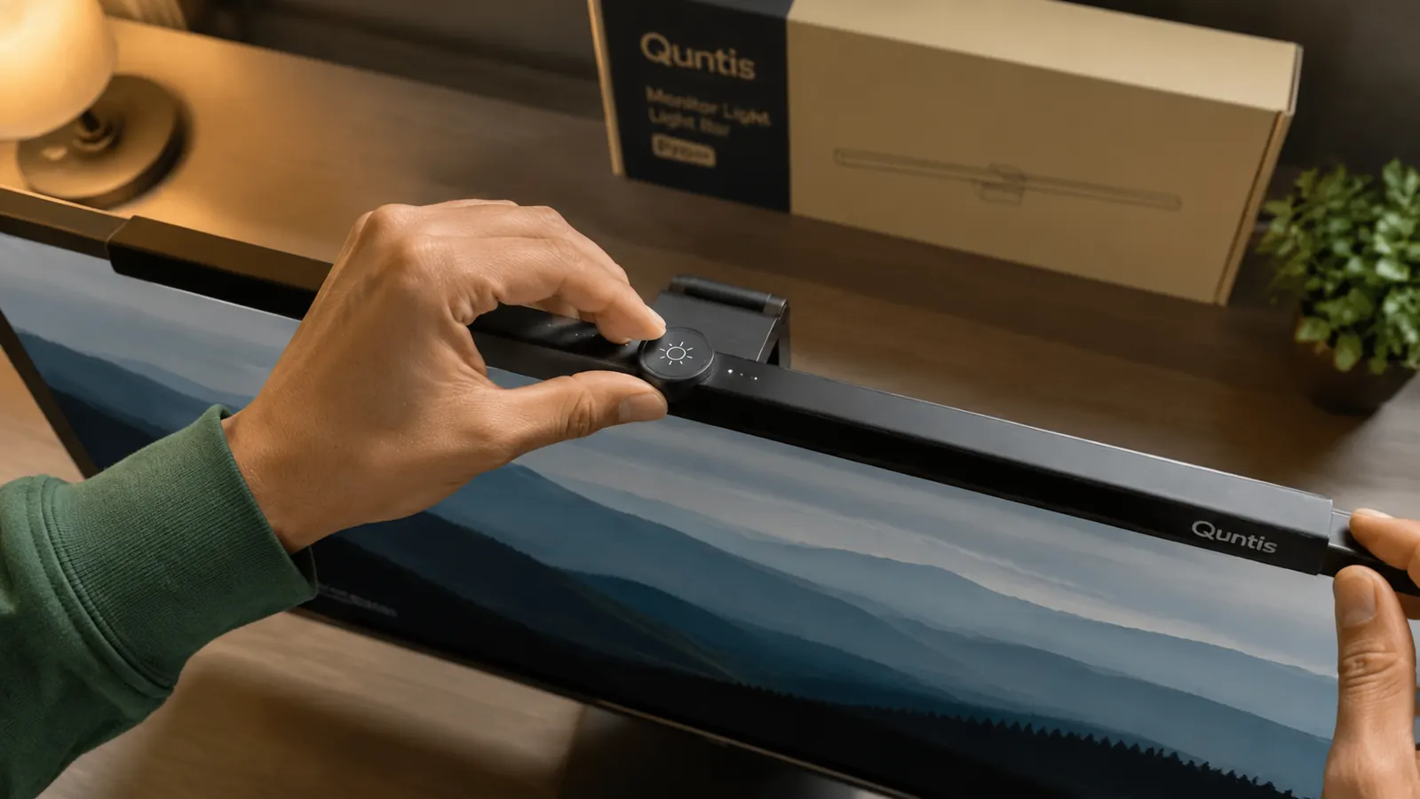 Person adjusting the touch controls on a monitor light bar, showing the brightness ring on top of the unit