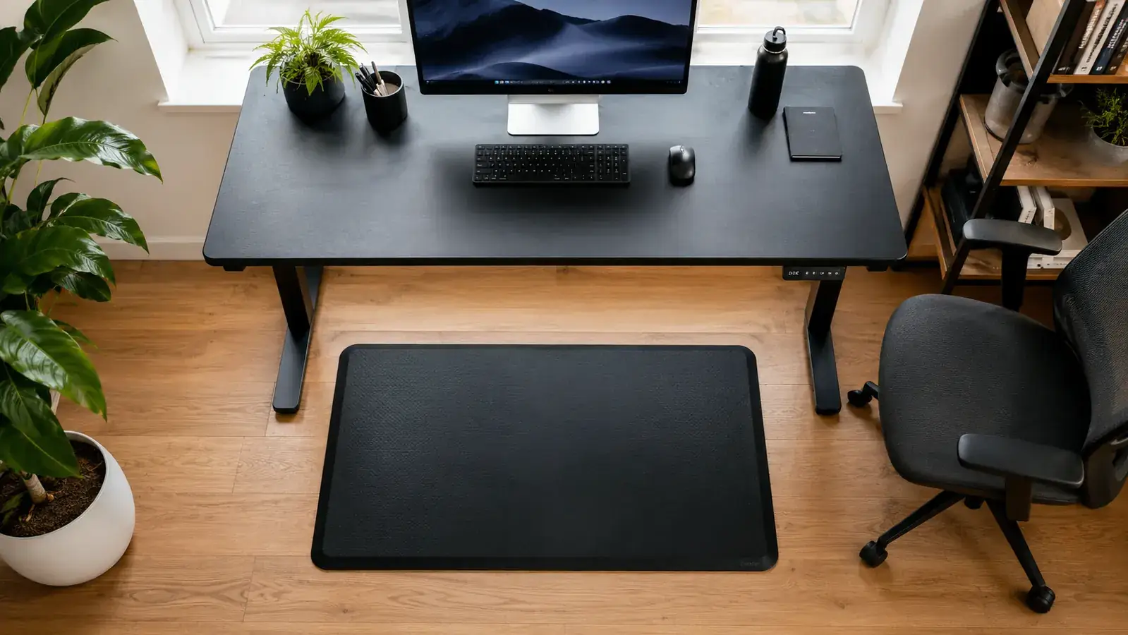 Home office floor area showing a mat positioned correctly relative to a standing desk converter