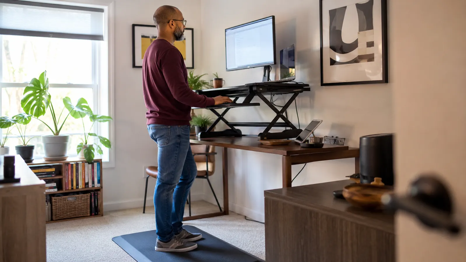 Person shifting weight and stretching legs on an anti-fatigue mat at a home standing desk
