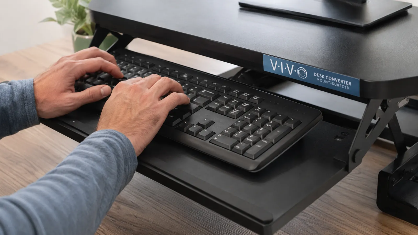 Close-up of the VIVO desk converter keyboard tray extended outward with a full-size keyboard and mouse on it